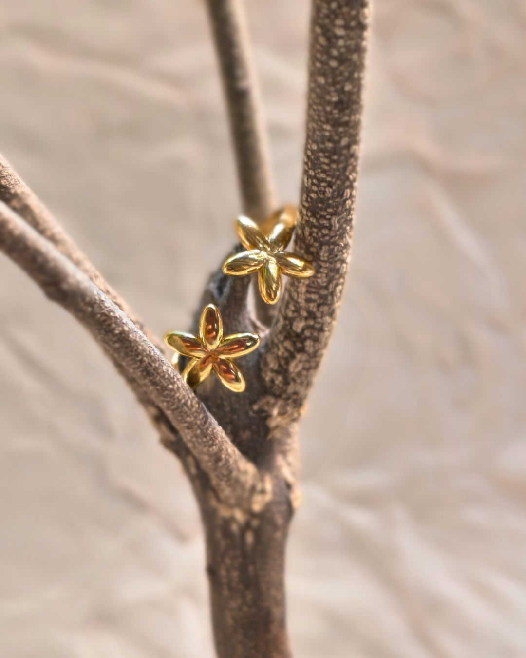Elegant adjustable gold plated floral ring with tiny flower details.