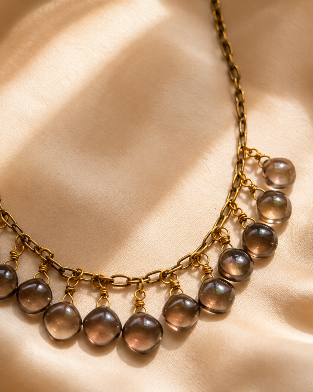Handmade Brazilian Smoky Quartz jewelry featuring thirteen natural gemstone drops suspended from an antique brass chain.