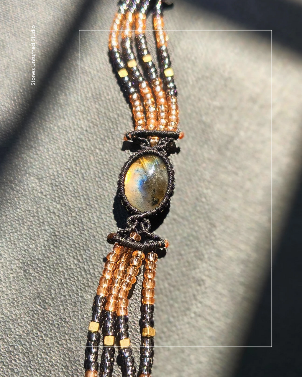 Handmade labradorite bracelet with black, copper, and metallic beads.