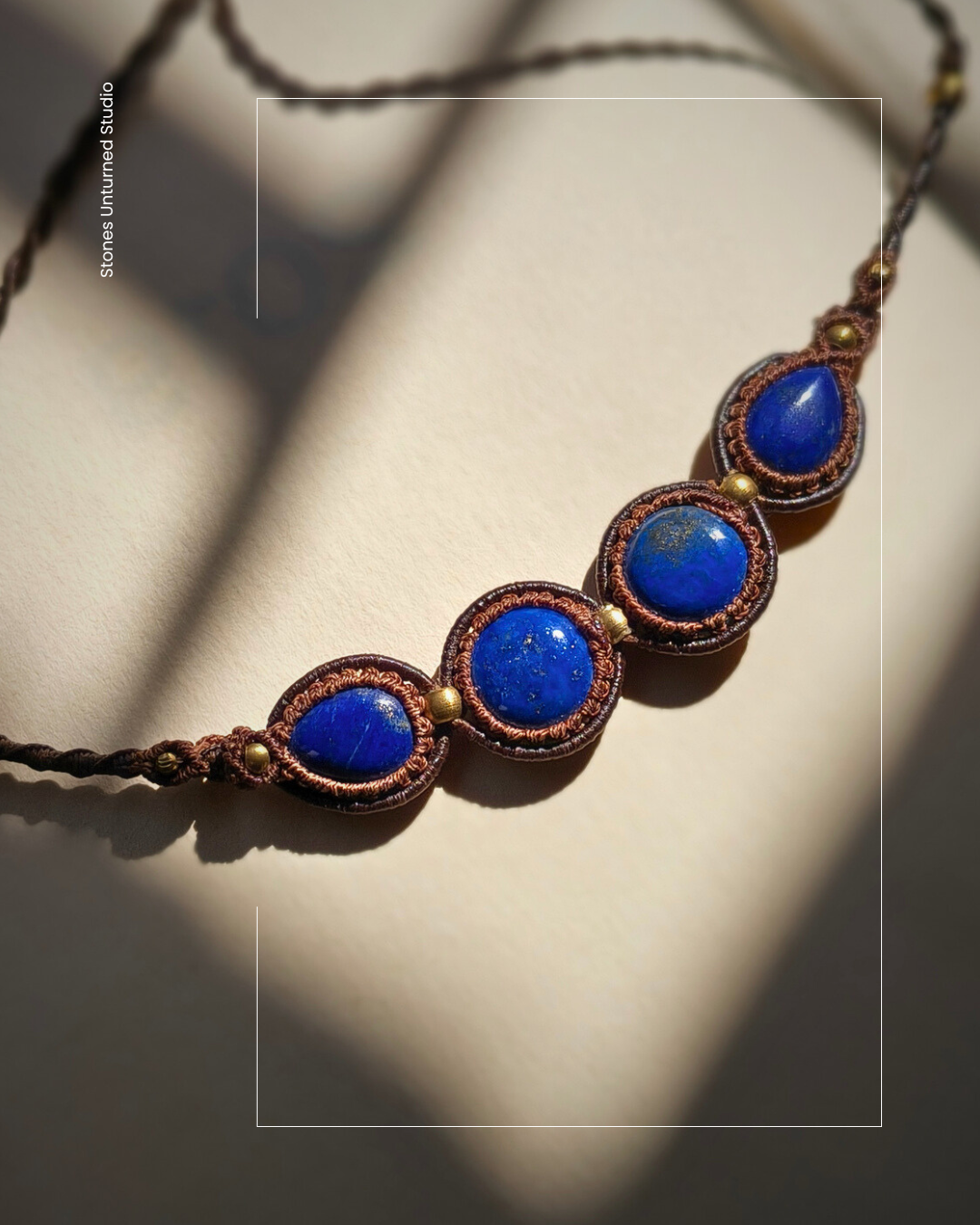 Close up of natural lapis stones in adjustable macrame necklace.