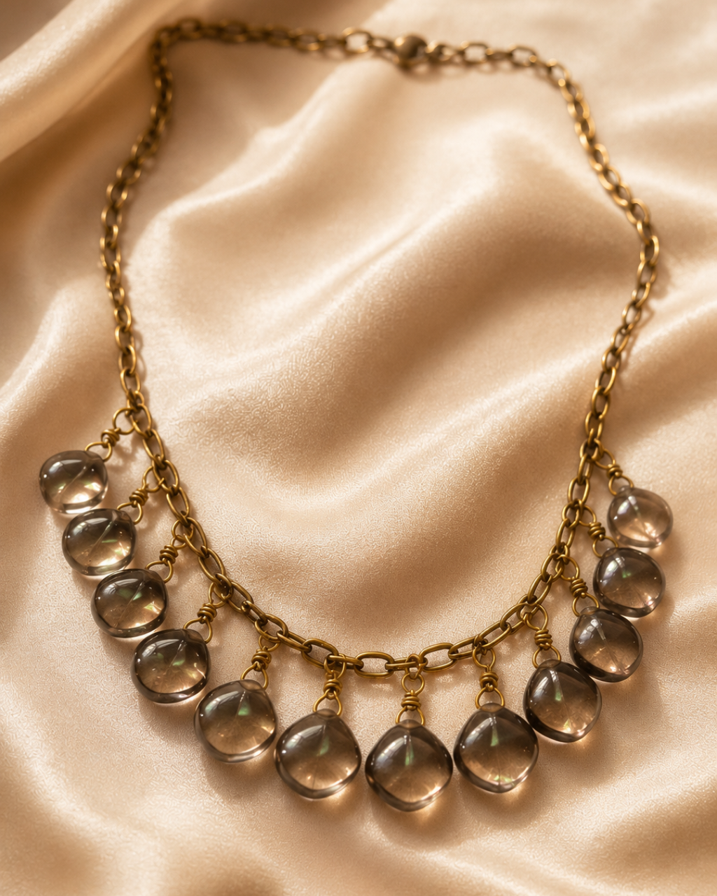 Close-up of a handmade Smoky Quartz necklace crafted with natural Brazilian Smoky Quartz gemstones and finished with an adjustable antique brass chain.