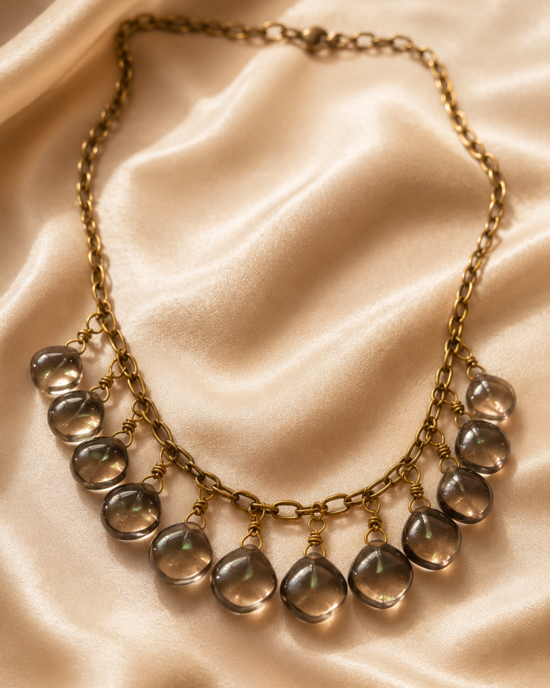 Close-up of a handmade Smoky Quartz necklace crafted with natural Brazilian Smoky Quartz gemstones and finished with an adjustable antique brass chain.