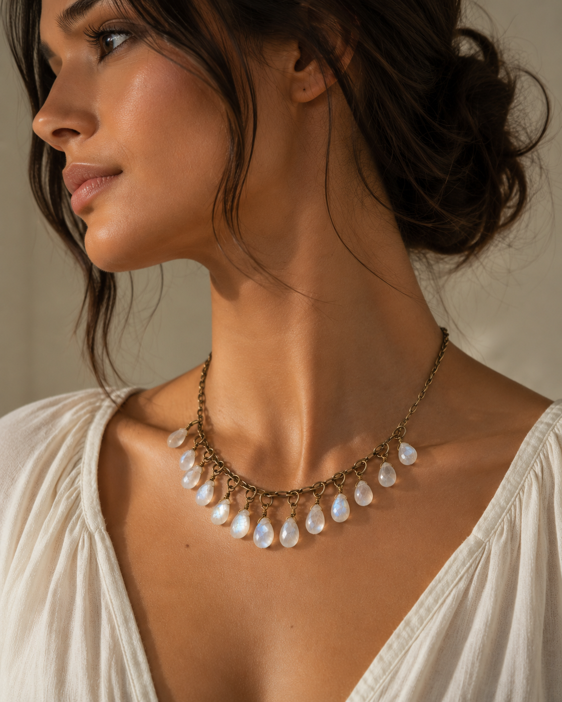 Handcrafted moonstone necklace photographed in soft golden sunlight showing luminous natural gemstone flashes.