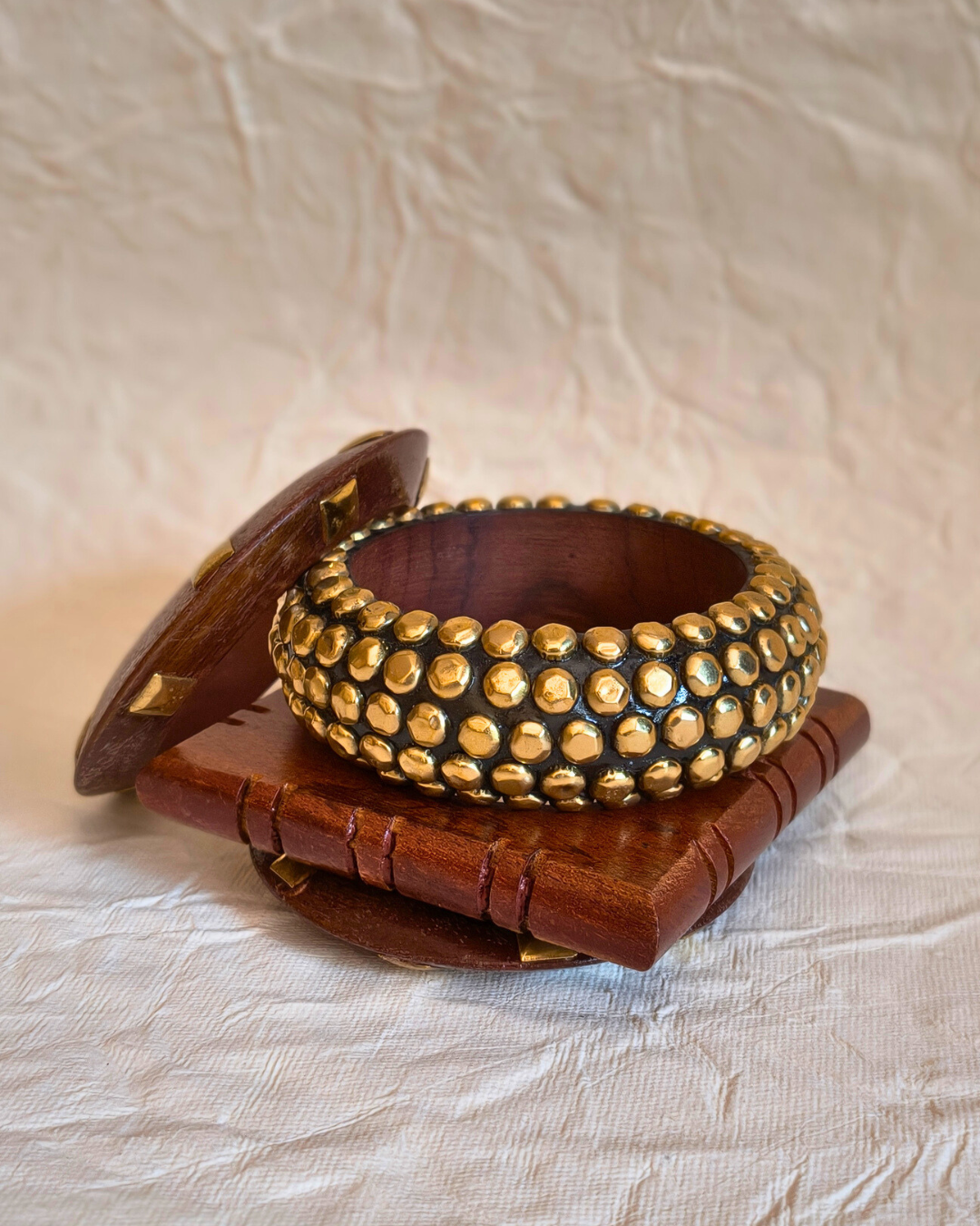 Boho style wooden bangle set with mixed shapes and natural finish.