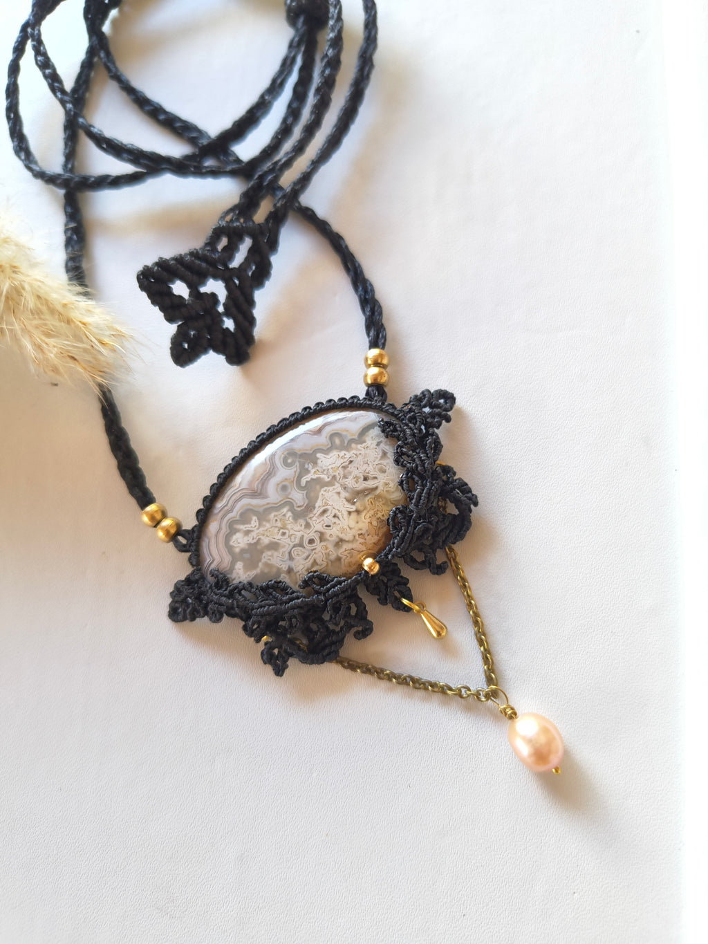 Close-up of crazy lace agate cabochon showing natural cream and amber banding