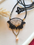 Crazy lace agate macramé locket necklace with pearl dangle from Demeter Collection, flat lay