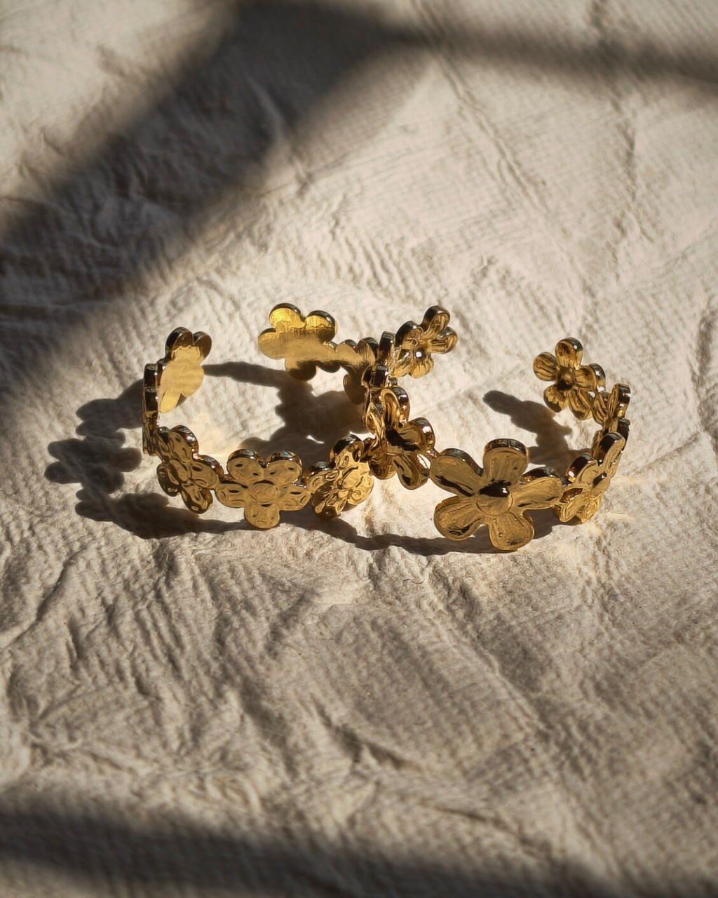 Dainty floral rings with tiny blooms arranged in a vine pattern.