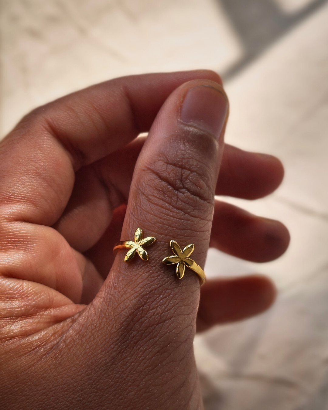 Skin safe stainless steel gold floral ring for everyday wear.