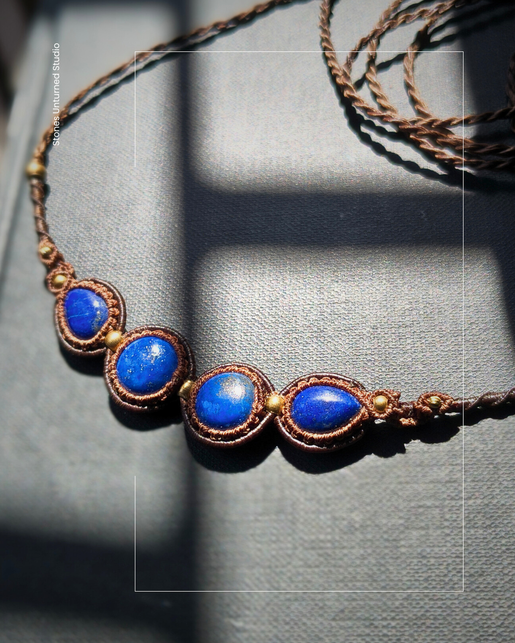 Elegant lapis lazuli necklace worn on display with natural light.
