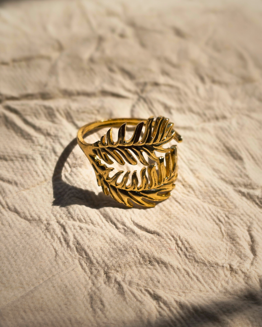Adjustable anti tarnish stainless steel gold fern ring for everyday wear.