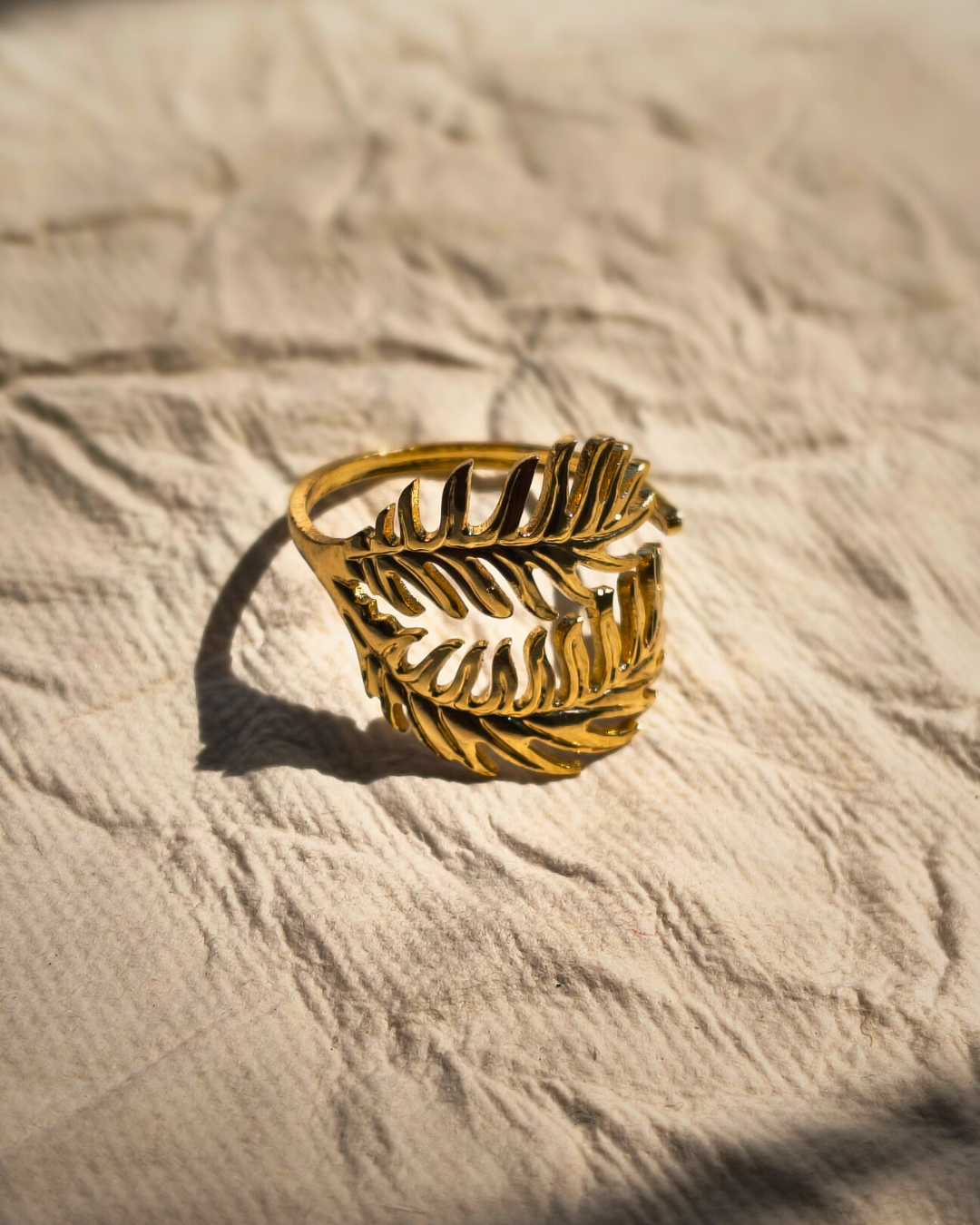 Adjustable anti tarnish stainless steel gold fern ring for everyday wear.