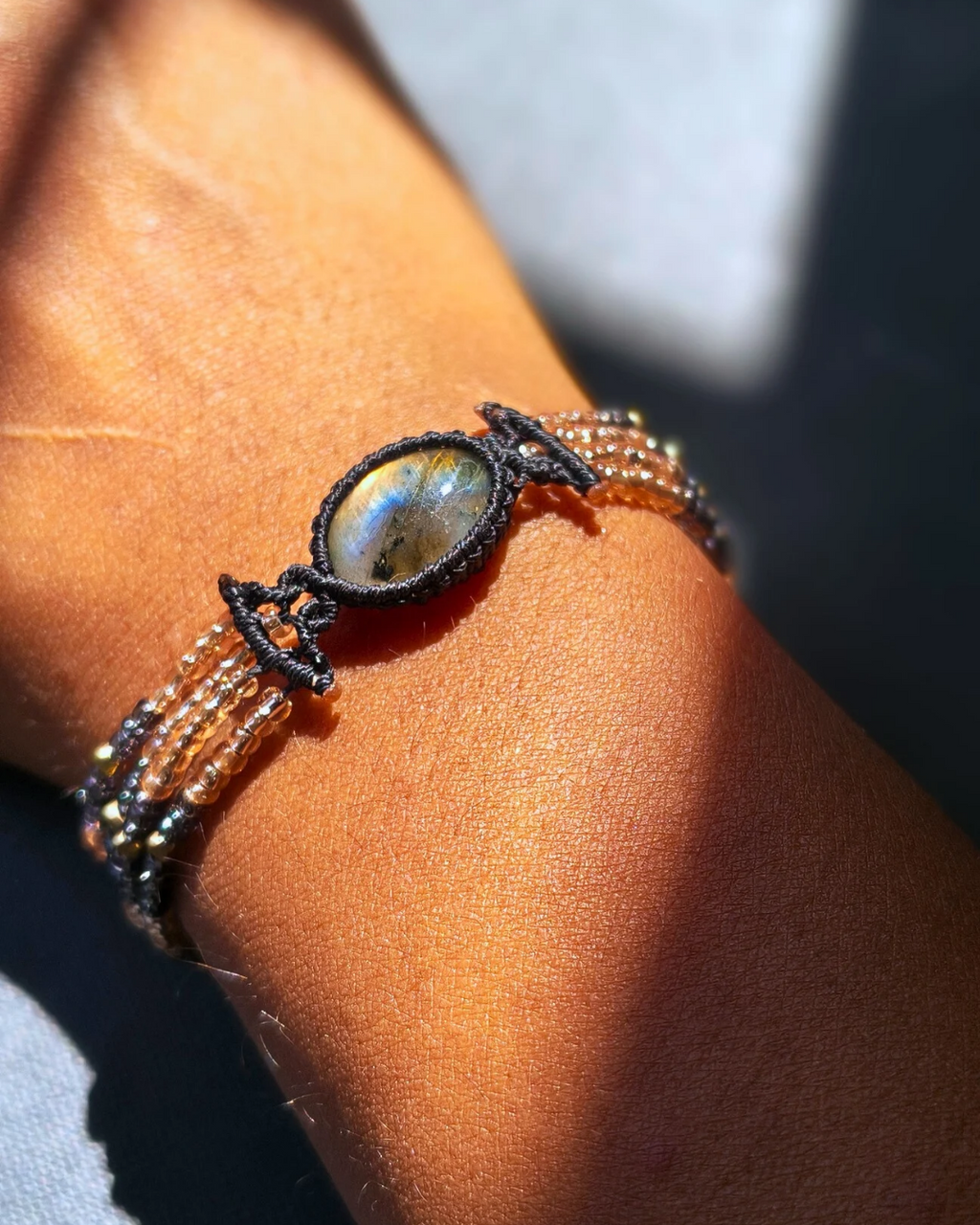 Handmade gemstone bracelet with labradorite and adjustable gold clasp.