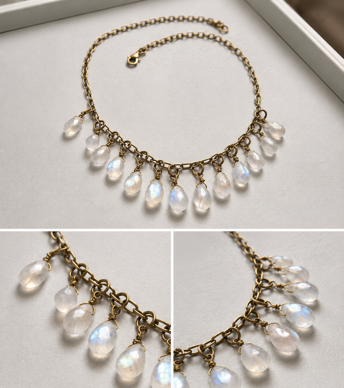 Handmade high fire rainbow moonstone drop necklace with antique brass chain displayed in soft natural light.
