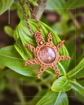 Close up of macrame sunstone sun pendant with radiant sun energy