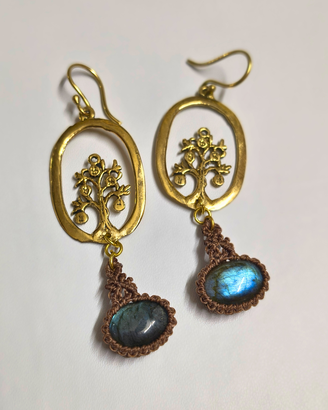 Handmade tree of life brass earrings with natural labradorite stones and brown macramé detailing on white background