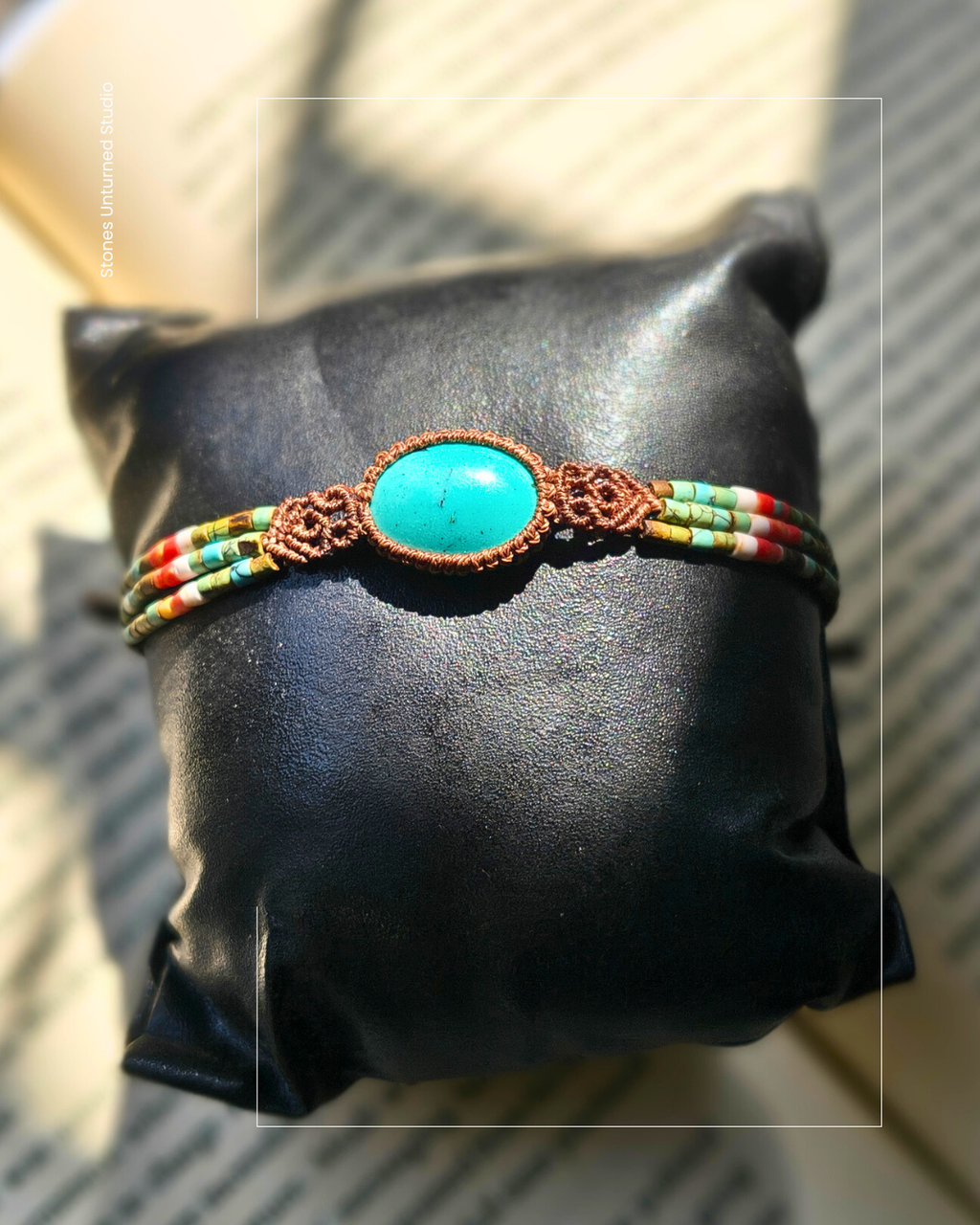 Handmade turquoise bracelet worn on wrist in natural sunlight.