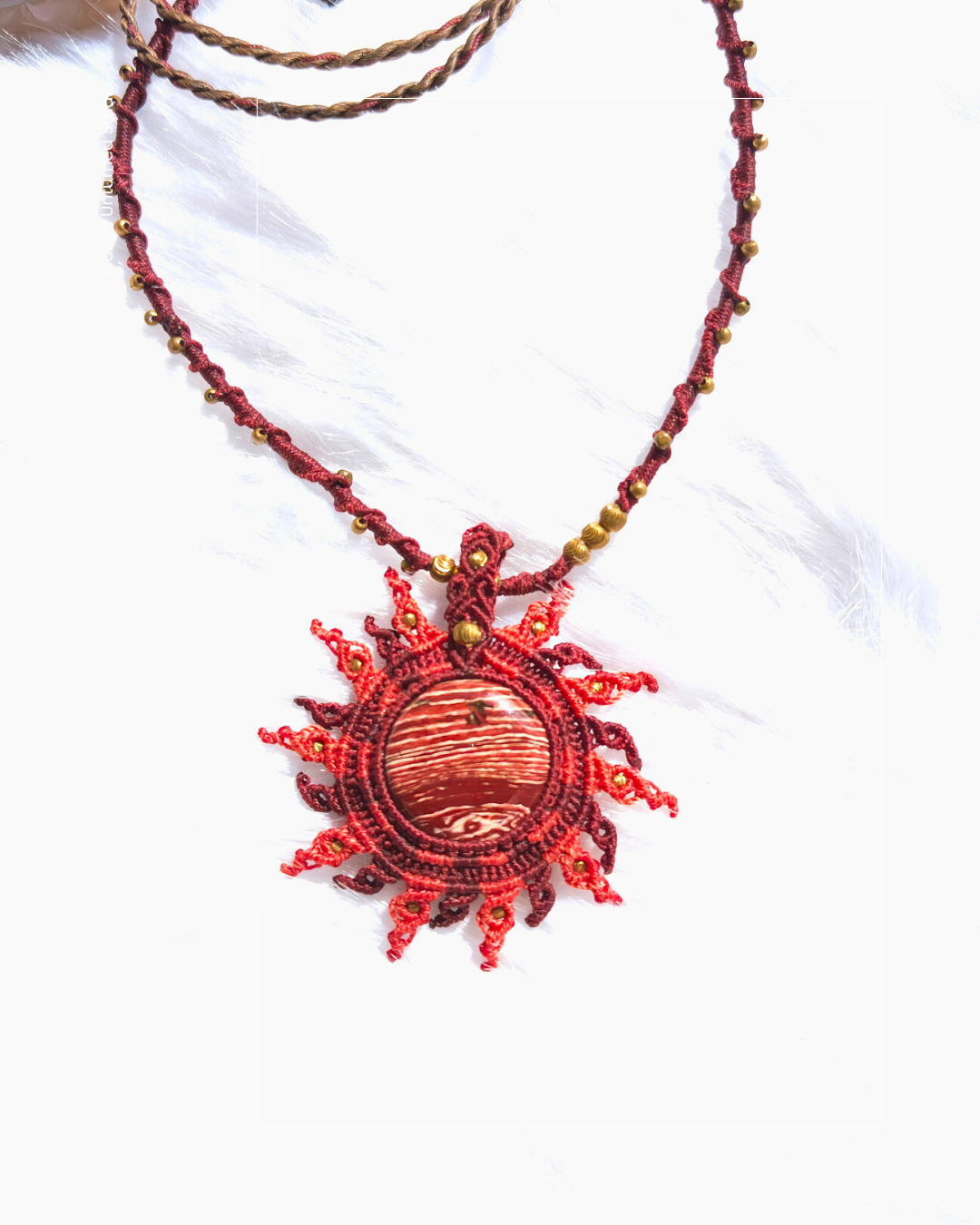 Handcrafted rainbow jasper pendant with brass bead details along the necklace