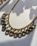 Alt Description: Handmade Hecate Smoky Quartz Necklace featuring 13 high-grade Brazilian Smoky Quartz gemstone drops hand wrapped on an antique brass chain.
