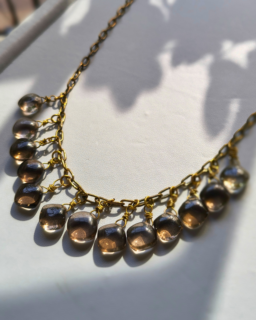 Alt Description: Handmade Hecate Smoky Quartz Necklace featuring 13 high-grade Brazilian Smoky Quartz gemstone drops hand wrapped on an antique brass chain.