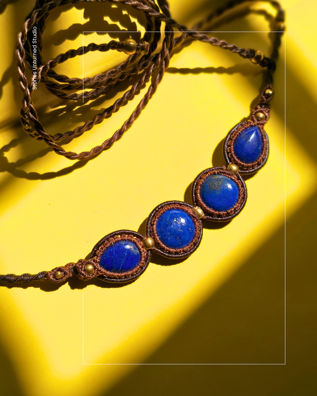 Handmade macrame necklace with four lapis lazuli stones and brass beads.