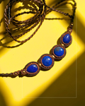 Handmade macrame necklace with four lapis lazuli stones and brass beads.