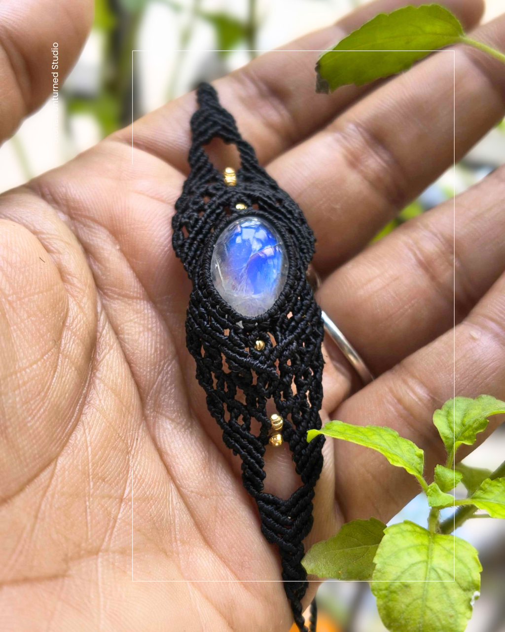 Handmade black macramé bracelet with natural moonstone gemstone and brass bead accents