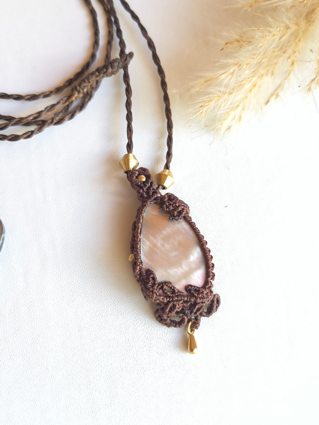 Mother of pearl teardrop pendant necklace from. Top view showing the brass drop and leaf design on the bottom and side