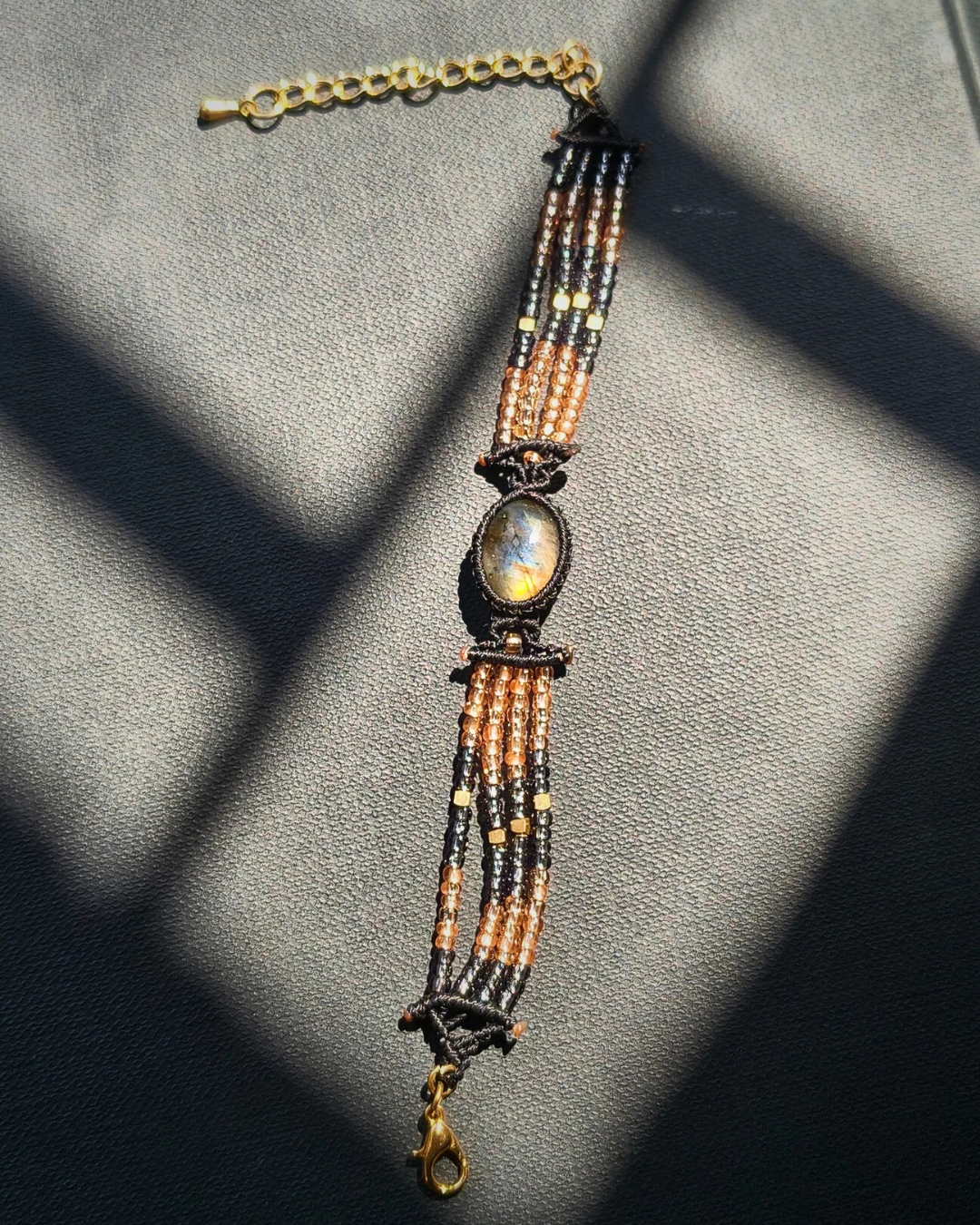 Labradorite bracelet with mystical blue and orange flashes in natural light.