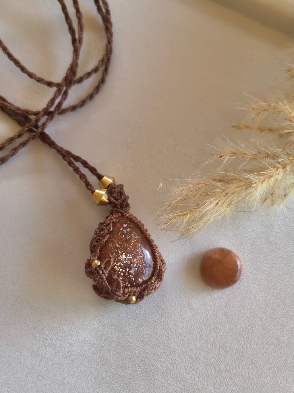 Natural sunstone teardrop pendant necklace showing flashes of radiance and glitter 