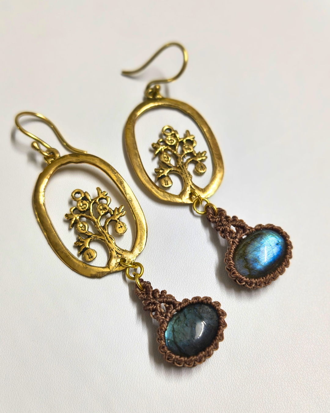 Flat lay photograph of nature Inspired handmade tree of life labradorite earrings on neutral background