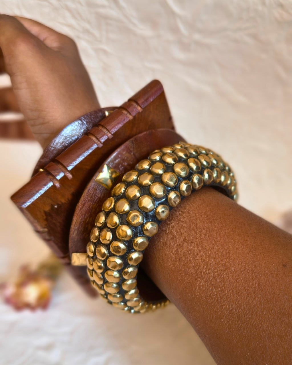 Natural wood bangles styled together for a layered look.
