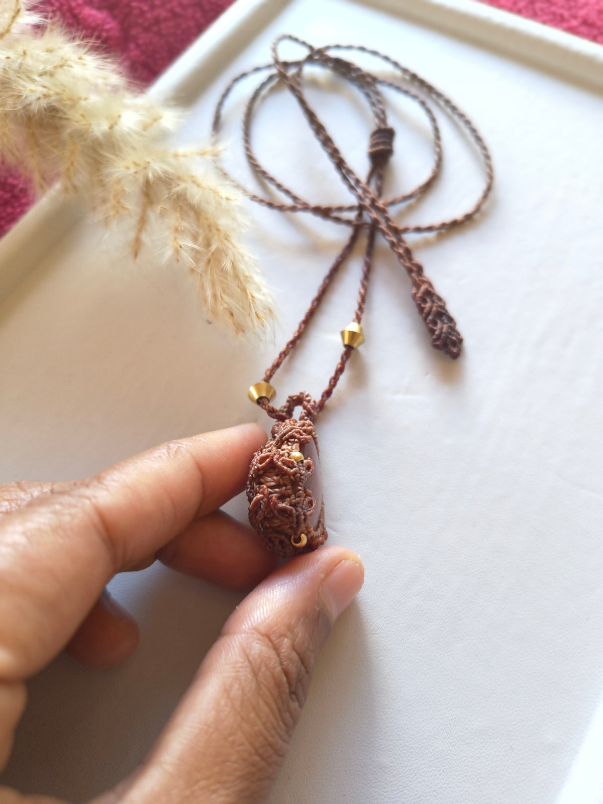 Side view of sunstone macramé pendant showing leaves details and handmade design 