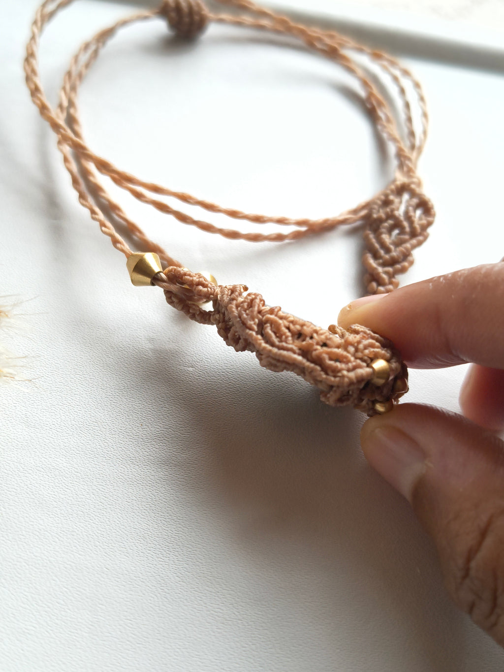 Side view of seraphinite macramé pendant showing leaf pattern and bead details 