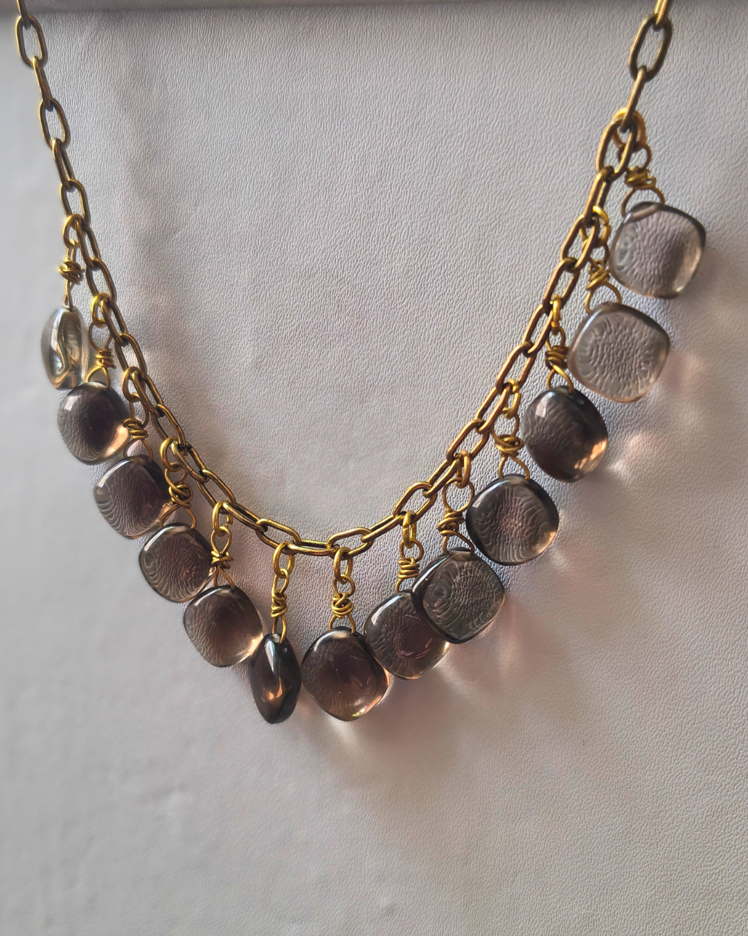 Elegant Smoky Quartz statement necklace with cascading gemstone drops and warm antique brass details.