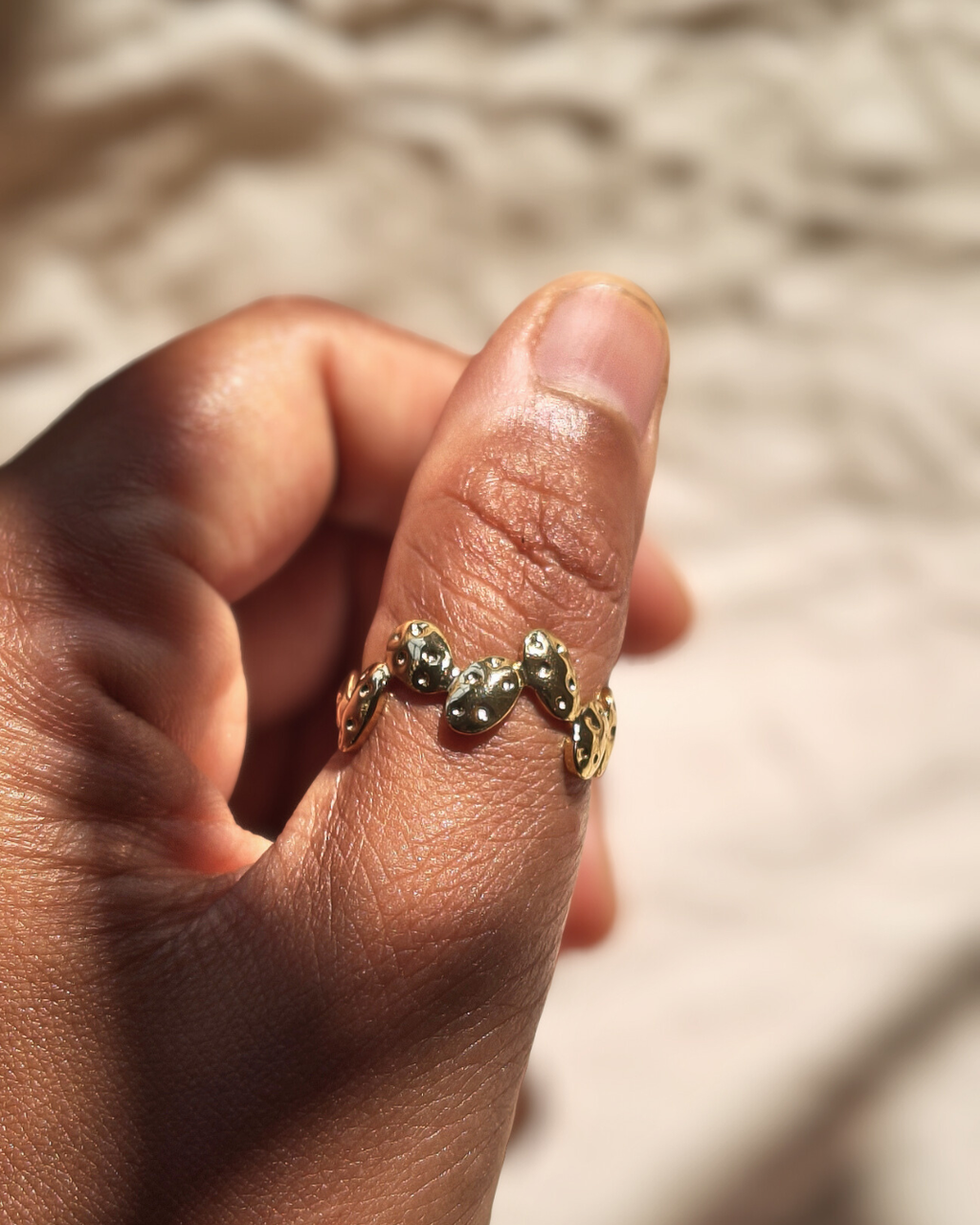 Stainless steel adjustable gold ring with pebble shaped details