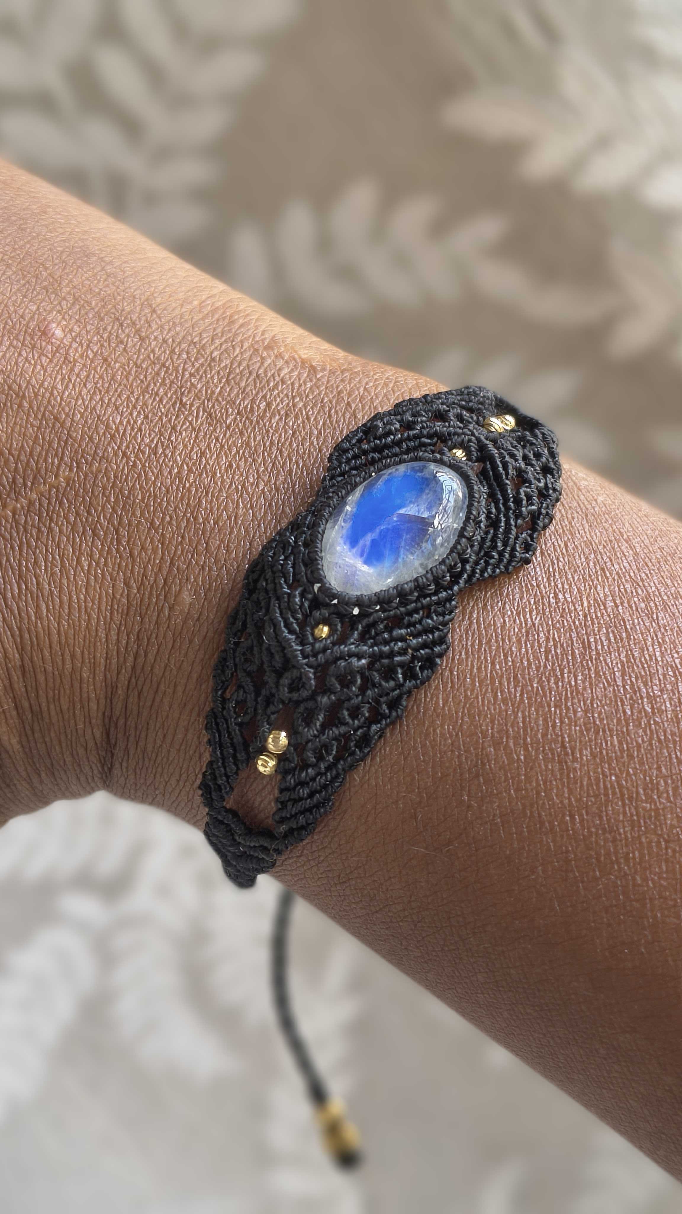 Video showing handmade black macramé bracelet with natural moonstone gemstone and intricate knotwork.