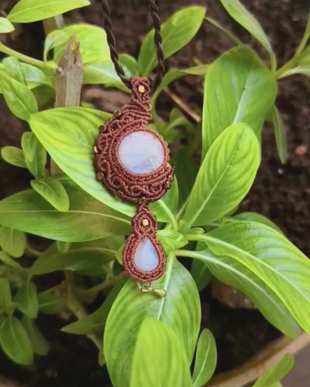Natural moonstone macramé necklace with crescent moon design and brass accents close up